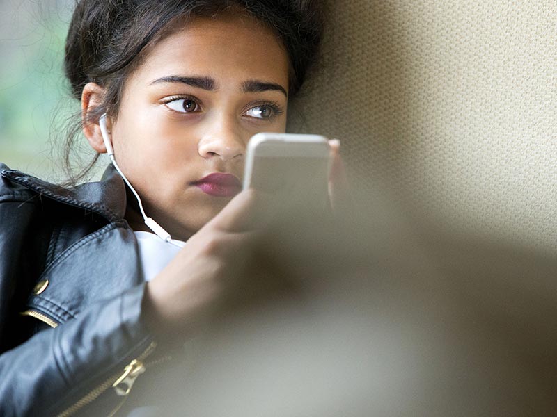 A young teenager on her mobile phone