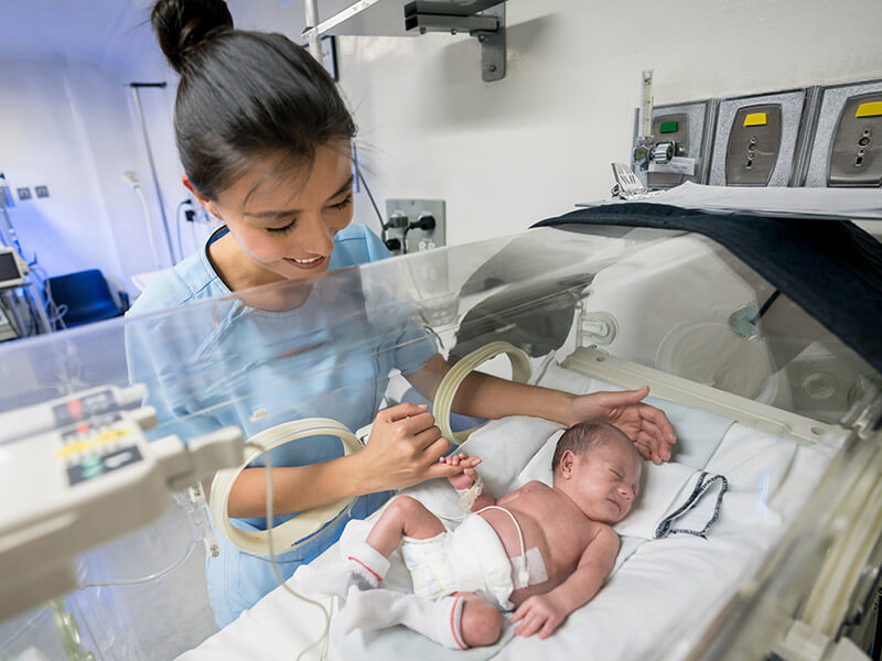 A baby care nurse looking after an infant