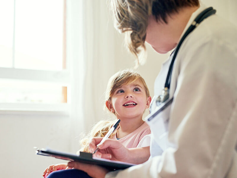 A doctor speaking to a young child