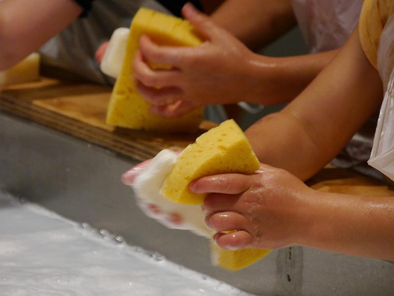 children washing with soap and sponges