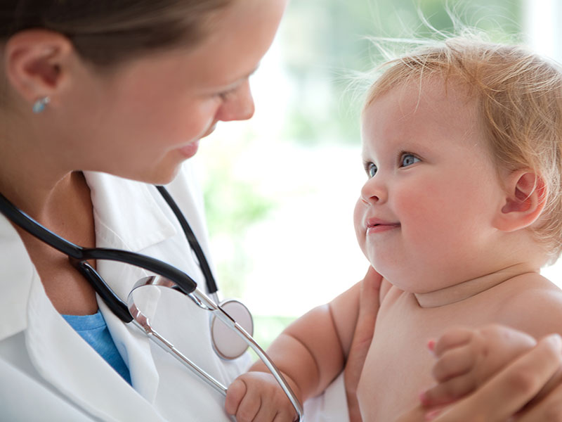A doctor on a home visit with a very young child