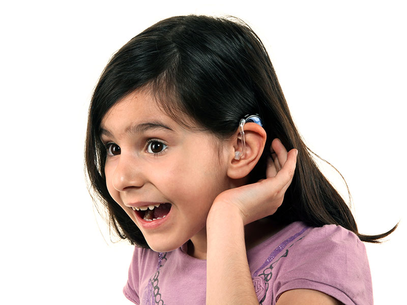 A child with a hearing aid