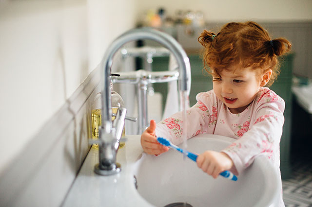 Child brushes teeth