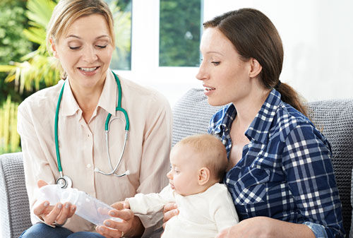 A mother taking advice from a Health Visitor